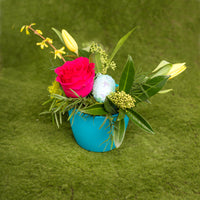 easter floral arrangement in a turquoise pot